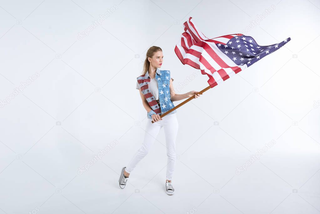 young woman waving USA flag