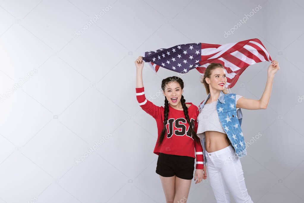 women standing and holding flag of USA