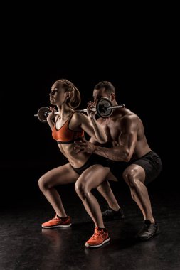 Couple exercising with barbell  clipart