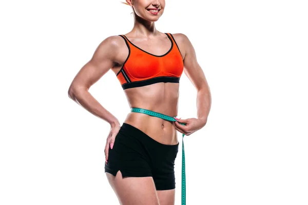 Sportswoman measuring her waistline — Stock Photo, Image