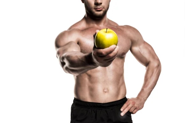 Desportista muscular segurando maçã — Fotografia de Stock