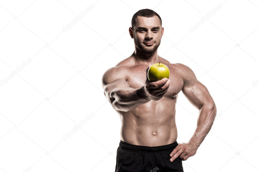 muscular sportsman holding apple