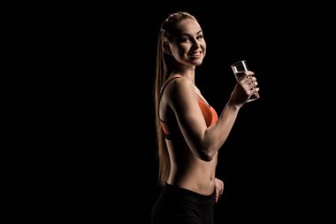 smiling sportswoman holding glass of water clipart