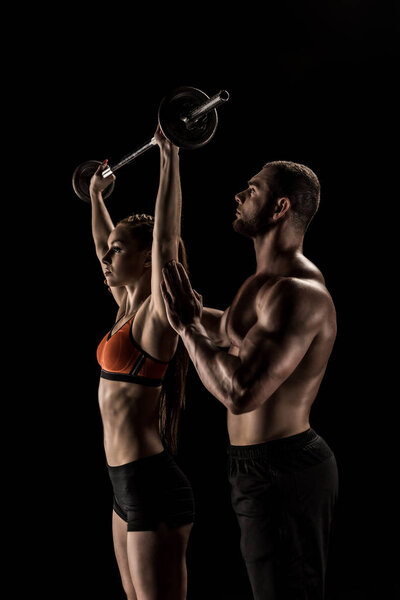 Couple exercising with barbell 