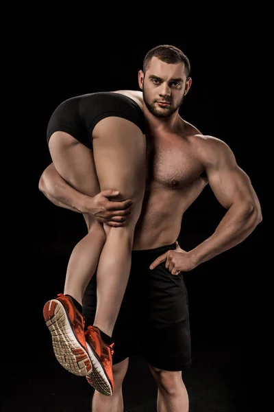 Sportive man holding woman — Stock Photo, Image