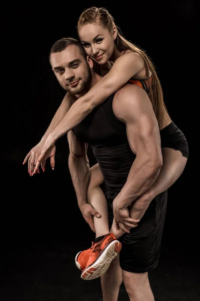 Sportive man holding woman — Stock Photo, Image