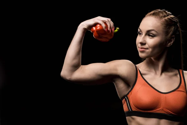 Sporty girl holding bell pepper — Stock Photo, Image