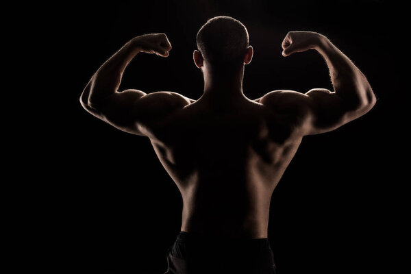 young shirtless athlete flexing biceps
