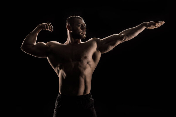 young shirtless athlete flexing muscles