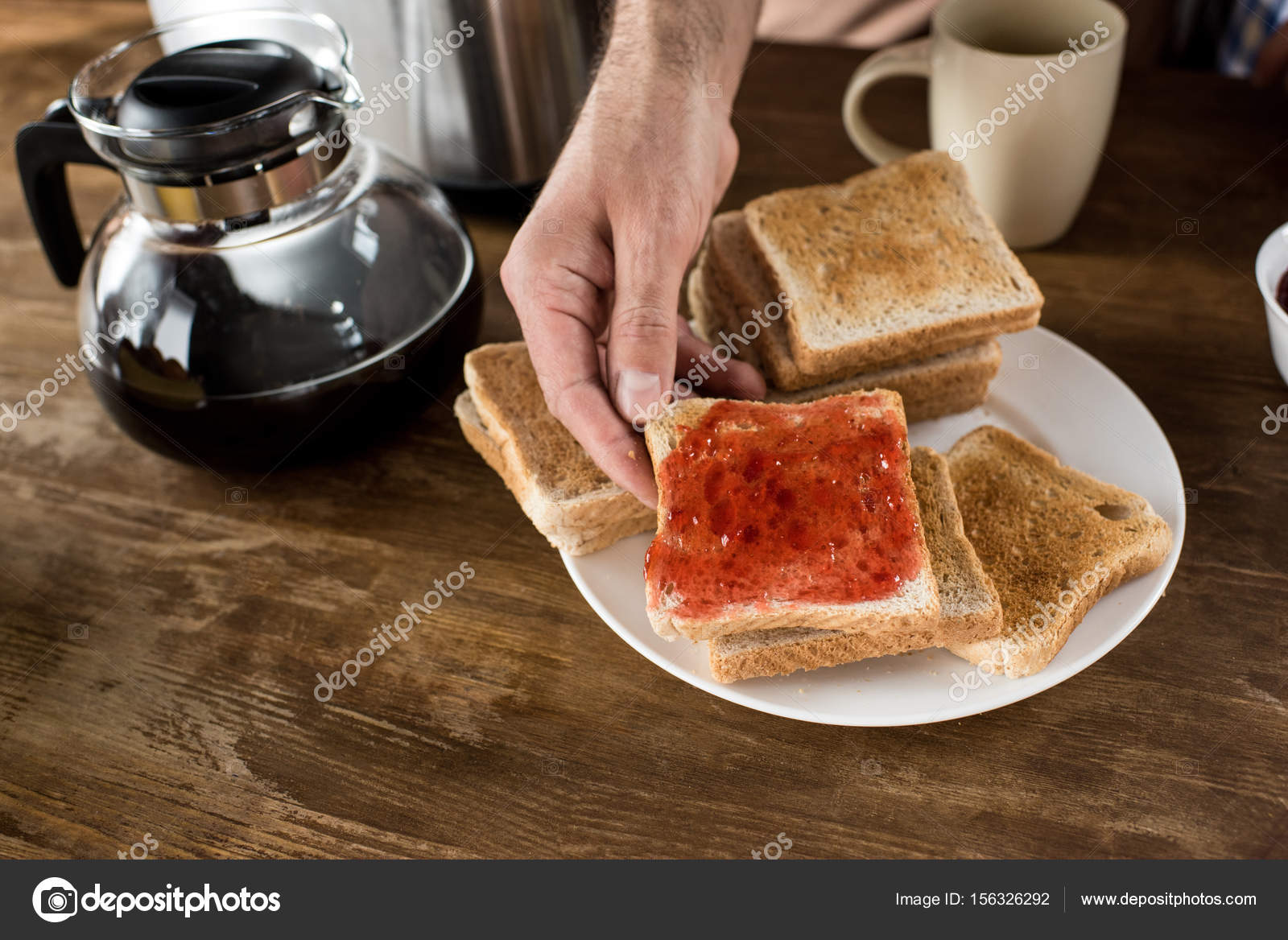 Man eating toasts Stock Photo by ©NatashaFedorova 156326292