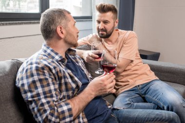homosexual couple drinking wine during talk  clipart