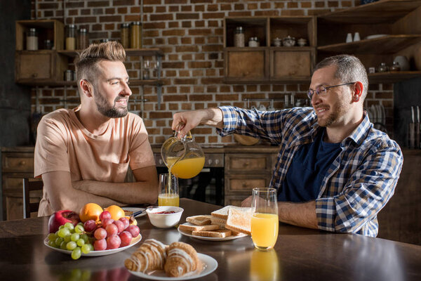 Gay couple having breakfast 