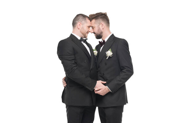 homosexual couple in suits able to kiss