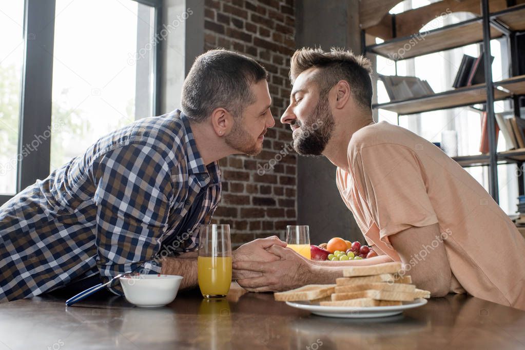 Gay couple having breakfast 
