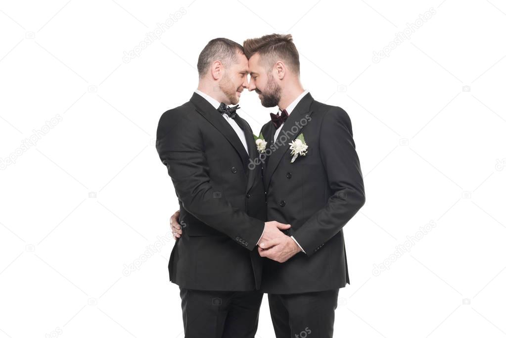 homosexual couple in suits able to kiss