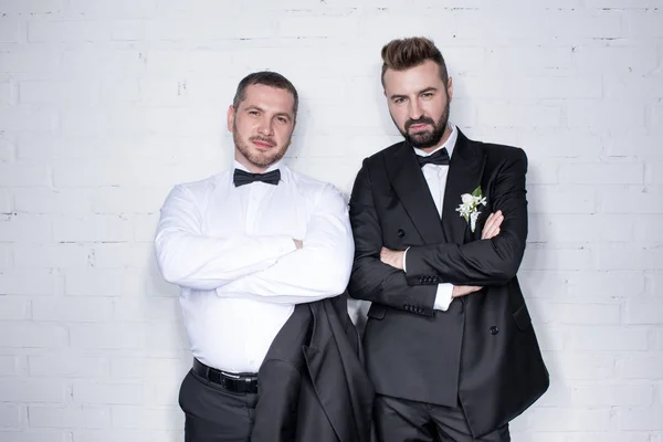 Couple of grooms posing with arms crossed — Stock Photo, Image