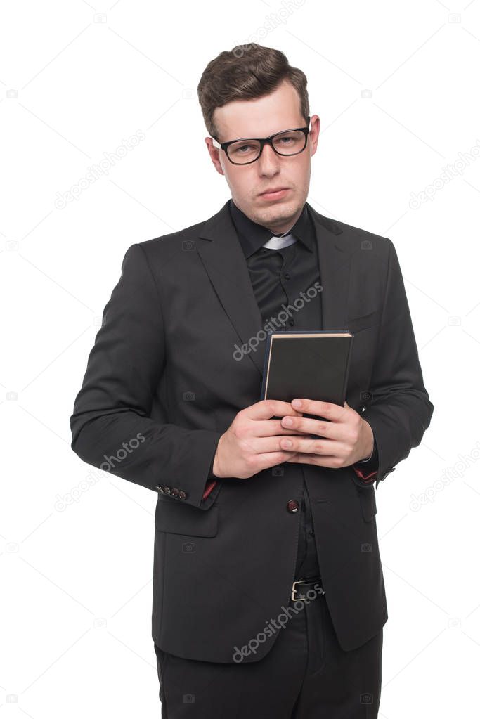 young priest holding scripture book