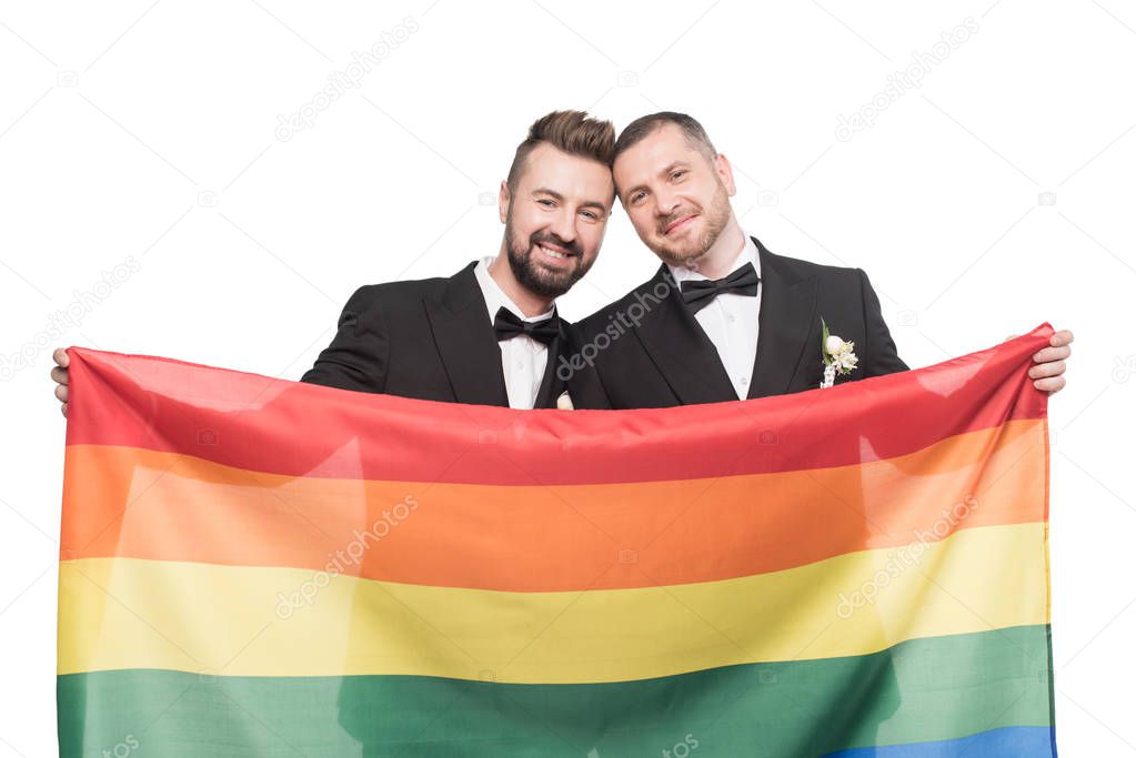 homosexual couple holding lgbt flag