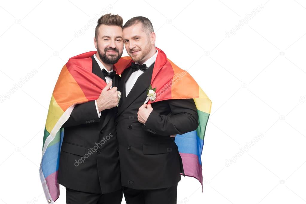 homosexual wedding couple with lgbt flag