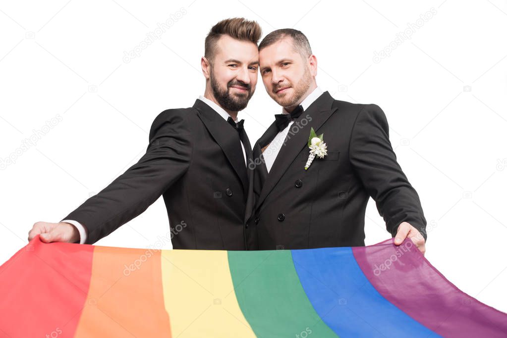 homosexual couple holding lgbt flag