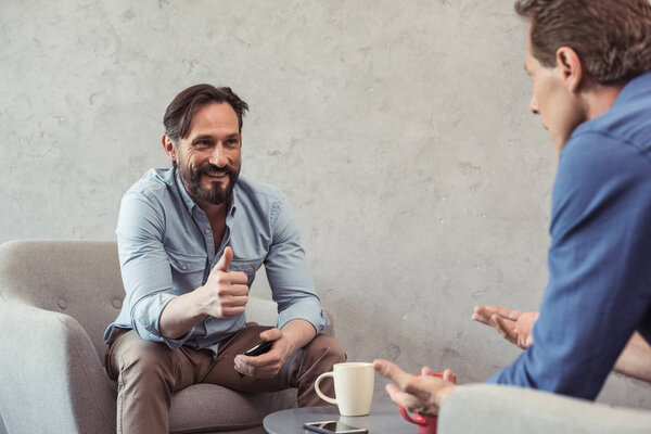 middle aged businessmen talking at break