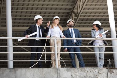 group of architects talking at construction site clipart