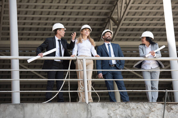 group of architects talking at construction site