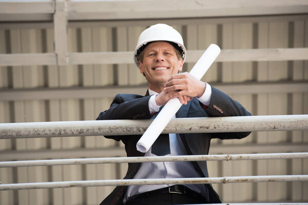 smiling middle aged architect in suit