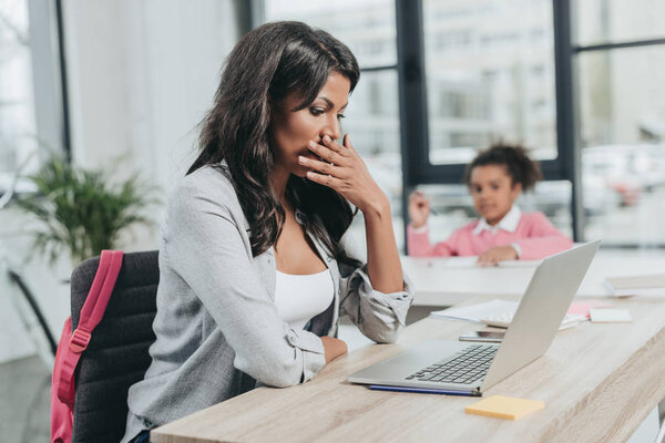 exhausted businesswoman at workplace