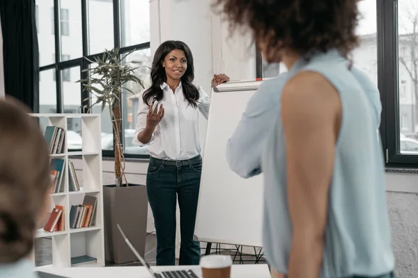 Woman providing business seminar for colleagues — Stock Photo, Image