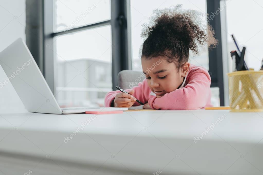 Little girl at office table 