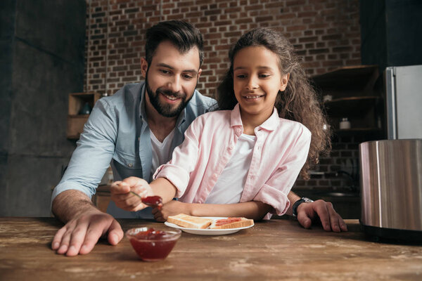 Father and daughter eating toasts 3