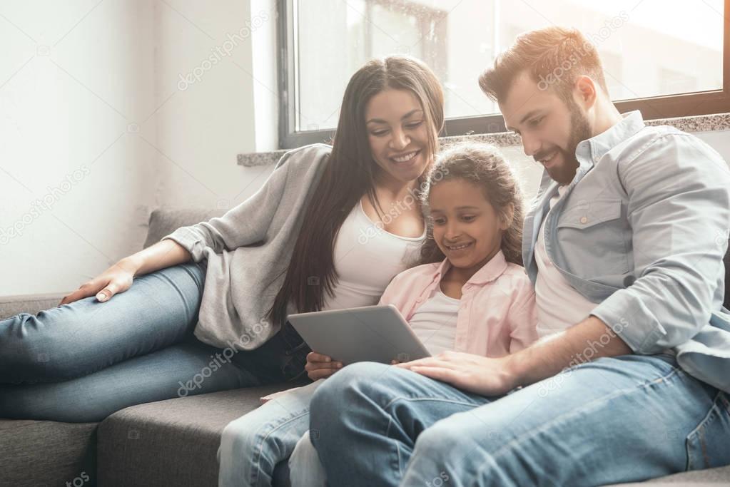 family using digital tablet