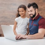 Padre e figlia con laptop