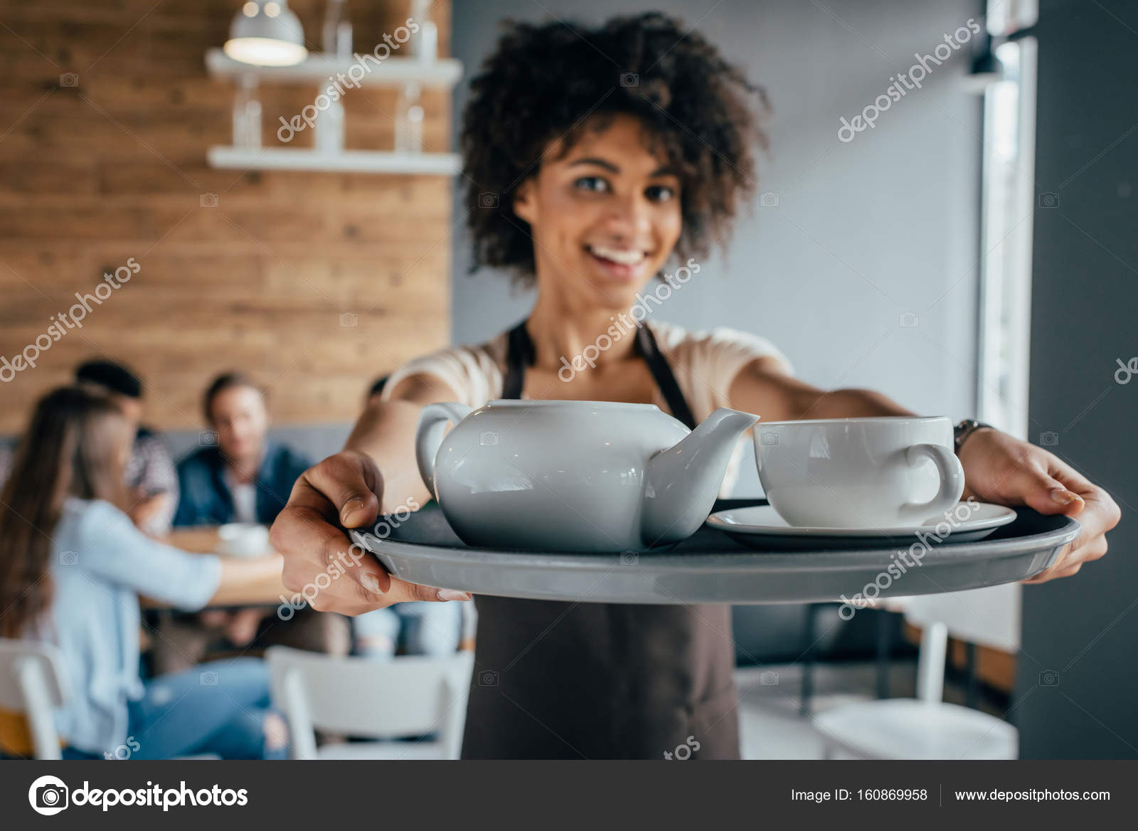 Smiling african american waitress Stock Photo by ©NatashaFedorova 160869958