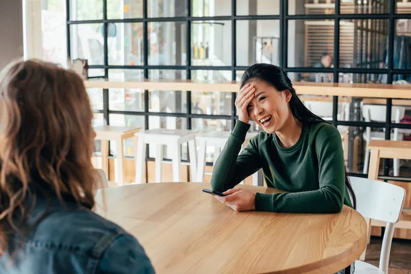 Pareja multiétnica sentada en la cafetería — Foto de stock gratis