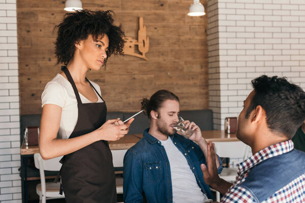 waitress taking orders from clients