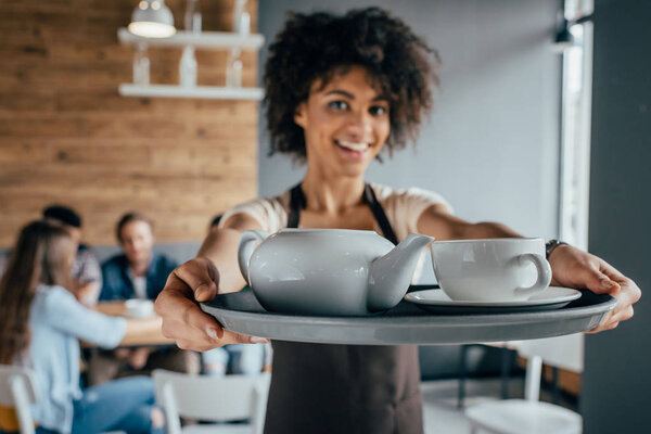 Smiling african american waitress