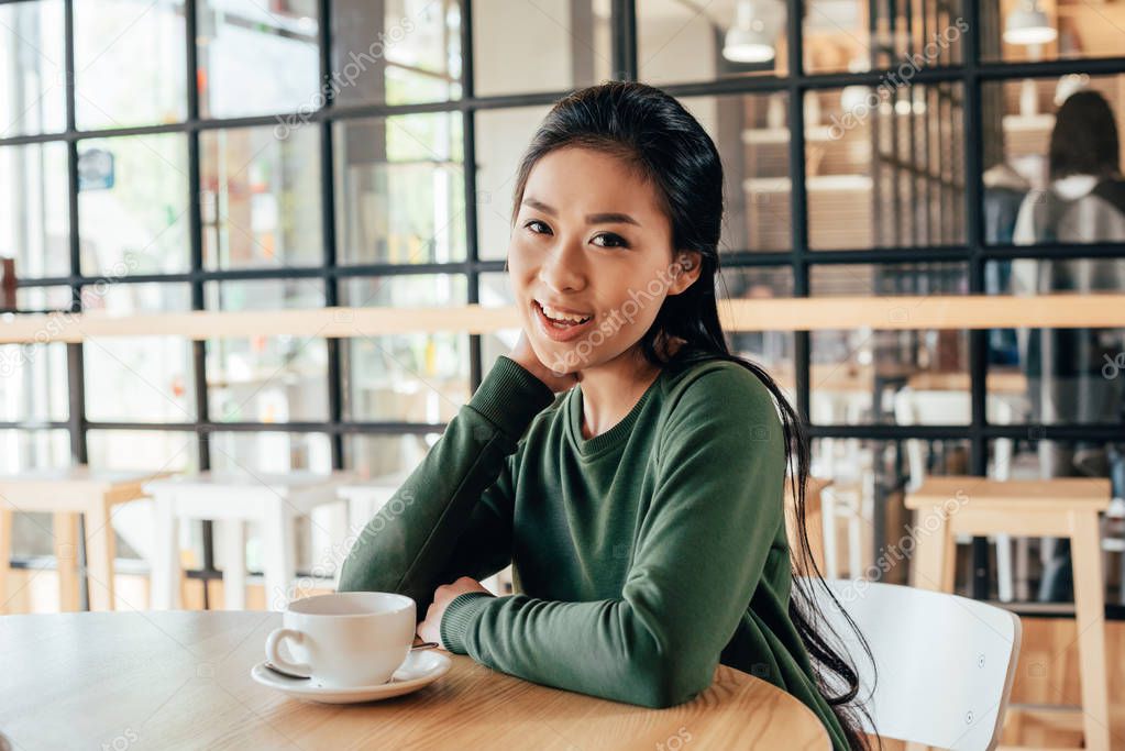 asian woman sitting in cafe