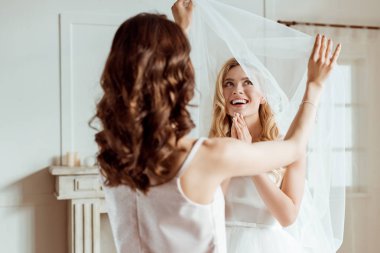 bridesmaid preparing bride for ceremony clipart