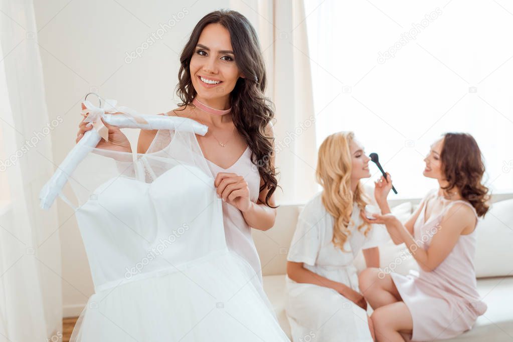 bride holding wedding dress