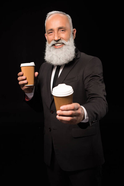 businessman holding coffee cups
