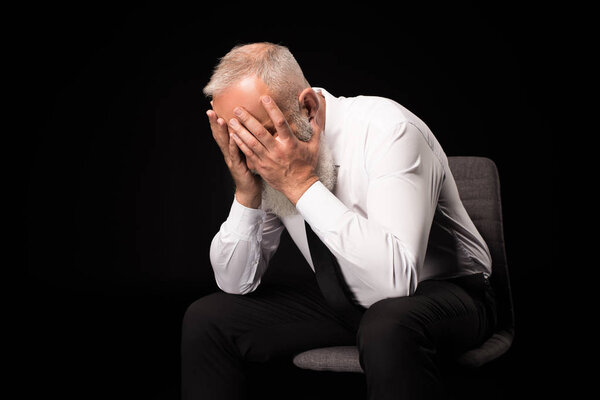 man hiding face in hands