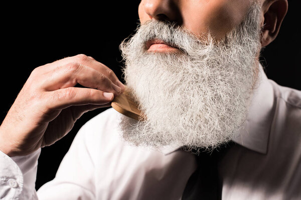 man combing long beard