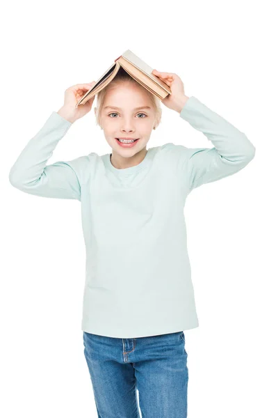 Schoolgirl with book on head — Stock Photo, Image