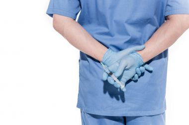 Doktor elinde şırınga tutuyor.