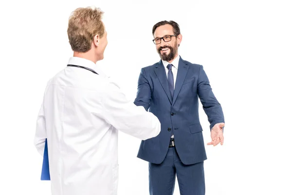 Бизнесмен и доктор пожимают руки — стоковое фото