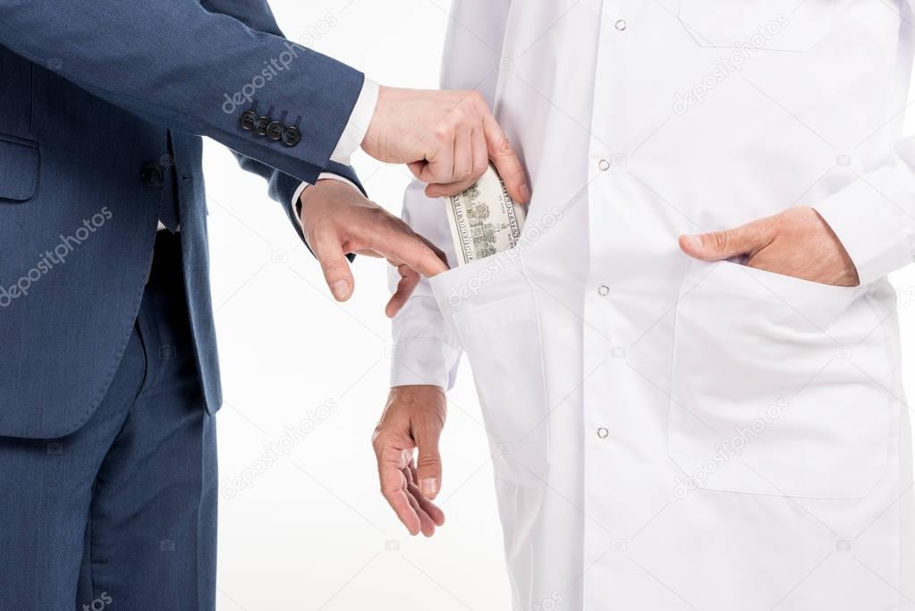 businessman giving bribe to doctor