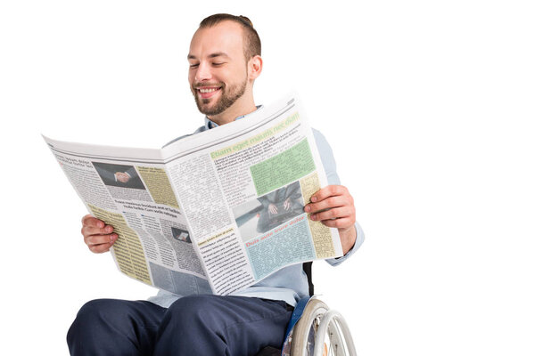 man in wheelchair reading newspaper