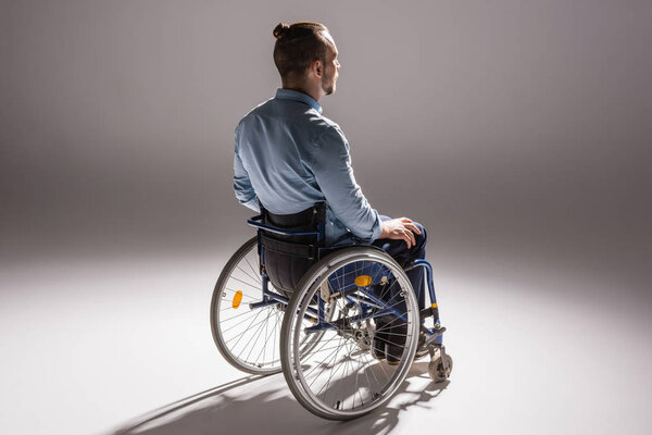 man on wheelchair casting shadow